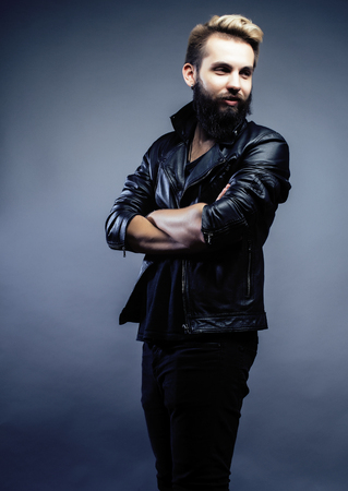 portrait of young bearded hipster guy on gray dark background close up, brutal modern man, lifestyle people conceptの写真素材
