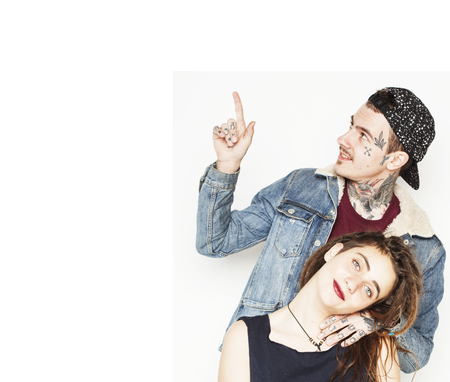Young couple together. A guy with tattoo and his girlfriend wearing dreadlocks
