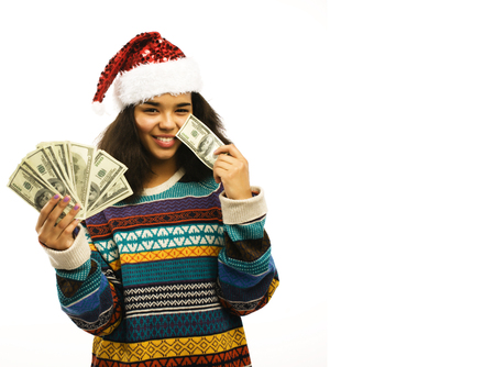 cute young african girl in santas red hat with money isolatedの写真素材