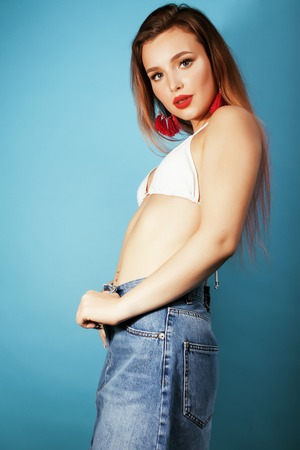 young pretty brunette girl in bikini smiling studio blue background close up, lifestyle people conceptの写真素材