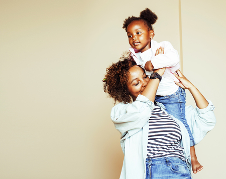 adorable sweet young afro-american mother with cute little daughの写真素材
