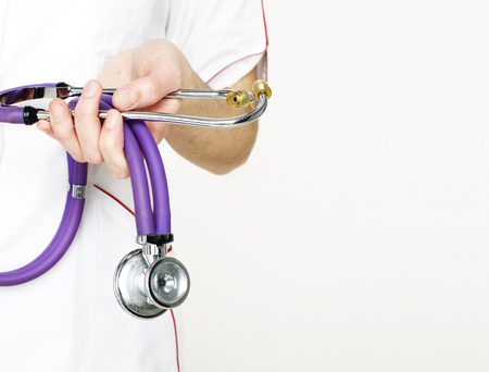 Close-up of female doctor holding stethoscope , focus on stethosの写真素材