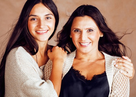 cute pretty teen daughter with mature mother hugging, fashion stの写真素材