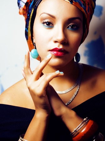 beauty bright african woman with creative make up, shawl on headの写真素材