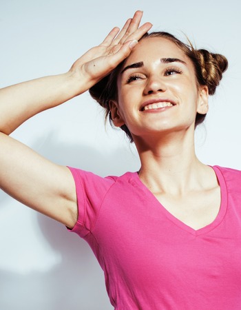 young pretty teenage hipster girl posing emotional happy smiling on white background, lifestyle people conceptの写真素材