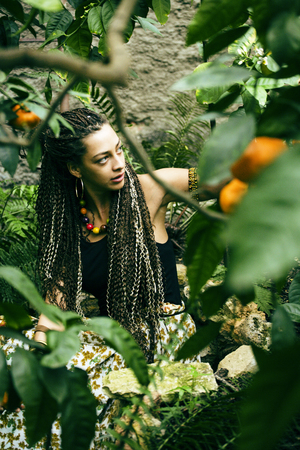 Young cute smiling woman in park with orangesの写真素材