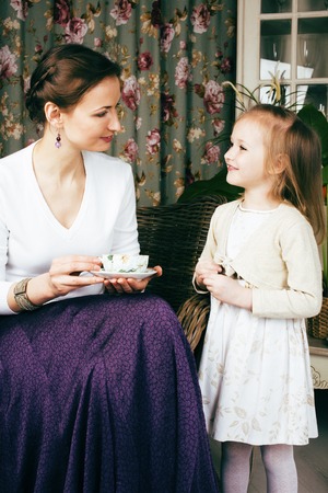young mother with daughter at luxury home interior vintageの写真素材