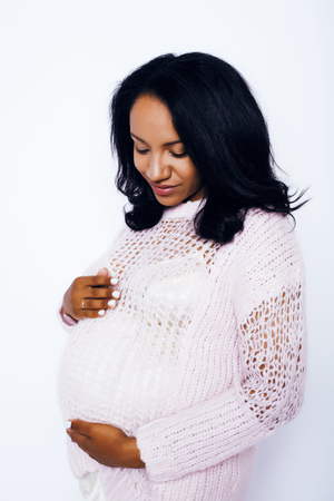young pretty african american woman pregnant happy smiling, posing on white background isolated , lifestyle people conceptの写真素材