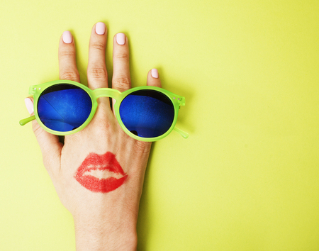 woman hand holding sunglasses on bright background, cosmetic sumの写真素材