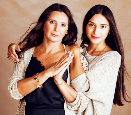cute pretty teen daughter with mature mother hugging, fashion stの写真素材
