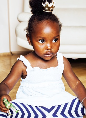 little cute african american girl playing with animal toys at hoの写真素材