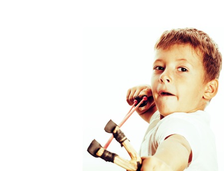little cute angry real boy with slingshot isolatedの写真素材