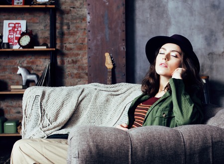 young pretty woman waiting alone in modern loft studio, fashionの写真素材