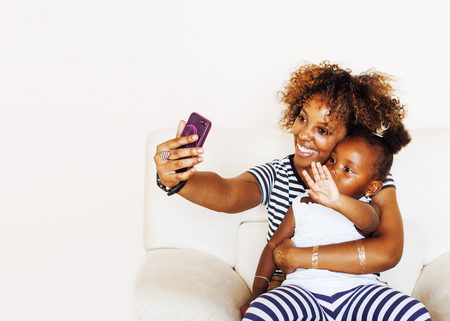 adorable sweet young american mother with cute little daughter,の写真素材