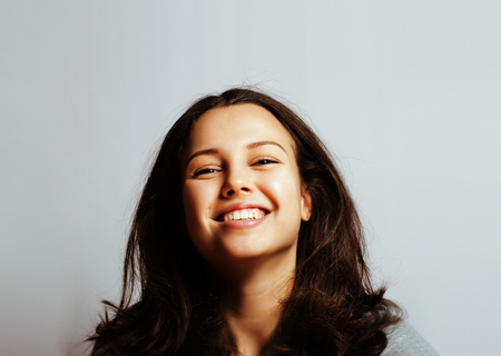 young pretty girl on white background gesturing adorable close upの写真素材