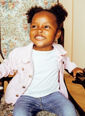 little cute african american girl playing with animal toys at hoの写真素材