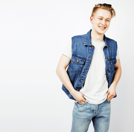 young handsome teenage hipster guy posing emotional, happy smiliの写真素材