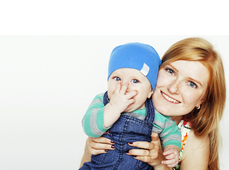 young beauty mother with cute baby, red head happy modern familyの写真素材
