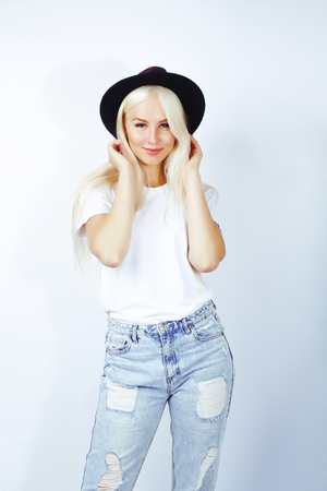 young pretty stylish blond hipster girl posing emotional isolateの写真素材