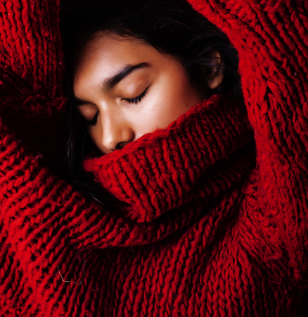 young pretty indian mulatto girl in red sweater posing emotional