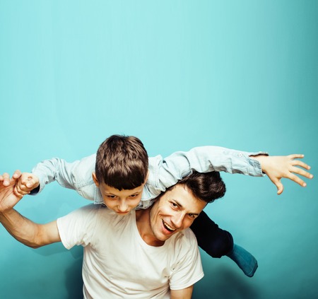 young pretty man model with little cute son playing together, li