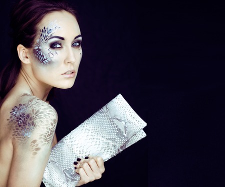 fashion portrait of pretty young woman with creative make up likの写真素材