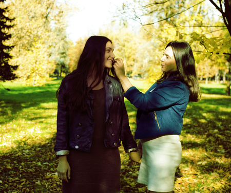 mature real mother with daughter outside autumn fall in parkの写真素材