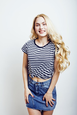 young pretty stylish blond hipster girl posing emotional isolateの写真素材