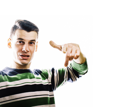 Portrait of a smart serious young man standing against white background. Emotional concept for gesture close upの写真素材