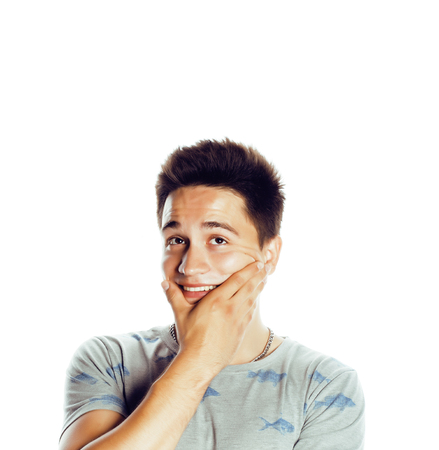 young handsome teenage hipster guy posing emotional, happy smiliの写真素材