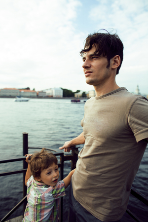 Young father hipster  and his little son on the river shore. Talの写真素材