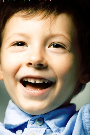 little cute boy with color pencils close up smiling