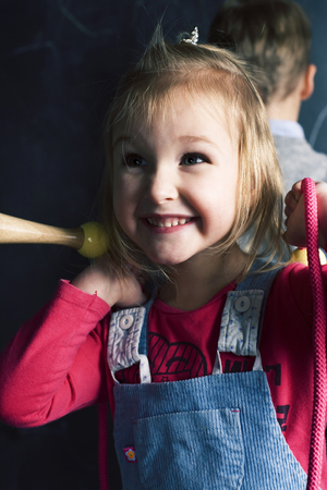 portrait of little cute girl near blackboard in classroom.の写真素材
