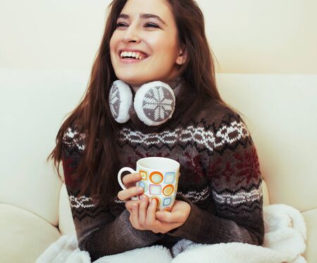 young pretty woman sitting in comfortable chair with coffee