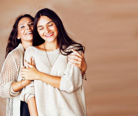 cute pretty teen daughter with mature mother huggingの写真素材