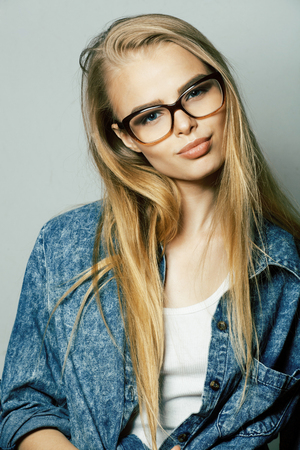 young pretty girl teenager in glasses on white isolated blond hair modern hipsterの写真素材