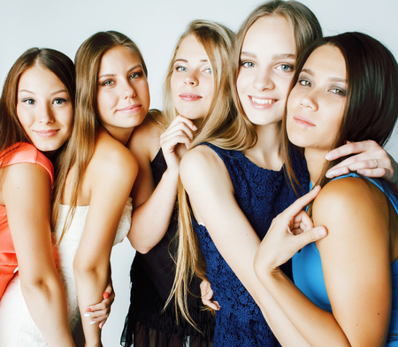 many girlfriends hugging celebration on white background, smiling talking chat, girl next door close up wondering sweety group, lifestyle real modern peopleの写真素材