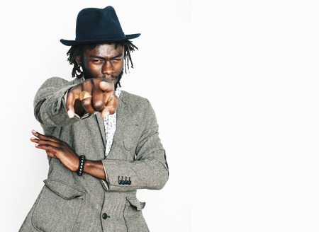 young handsome afro american boy in stylish hipster hat gesturing emotional isolated on white background smiling, lifestyle people concept close upの写真素材