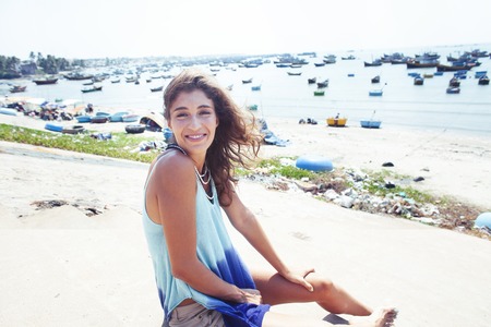 cute smiling young real woman in asian country sea port, vietnam traveller lifestyleの写真素材