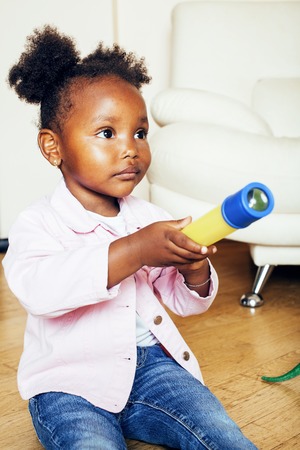 little cute african american girl playing with animal toys at home, pretty adorable princess in...