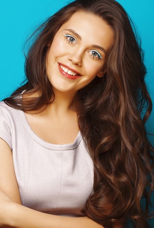 young pretty teenage modern girl posing emotional happy on blue background, lifestyle people conceptの写真素材