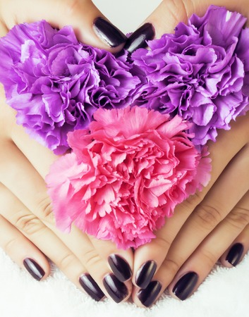 manicure pedicure with flower close up isolated on white perfect shape hands spa salon, modern dark maniの写真素材