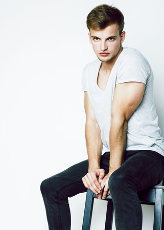 young handsome teenage hipster guy posing emotional, happy smiling against white background isolated, lifestyle people concept closeupの写真素材