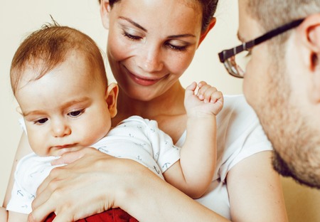 young happy modern family smiling together at home. lifestyle people concept, mother, father and little sonの写真素材