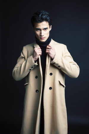 handsome asian fashion looking man posing in studio on black background, lifestyle modern people concept close upの写真素材