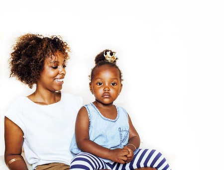 adorable sweet young afro-american mother with cute little daughter, hanging at home, having fun playing smiling, lifestyle people concept, queen girlの写真素材