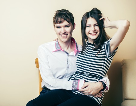 couple of happy smiling teenagers students, warm colors having a kiss, lifestyle people concept, boy and girl together close upの写真素材