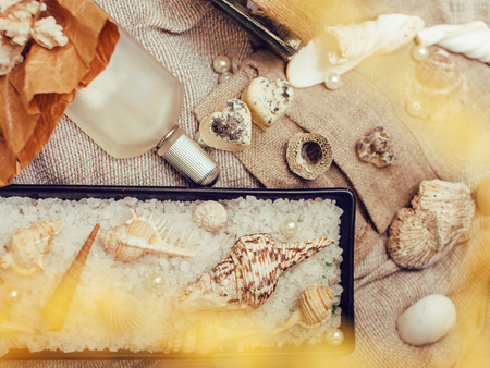 a lot of sea theme in mess like shells, candles, perfume, girl stuff on linen, pretty textured post card view vintage closeupの写真素材