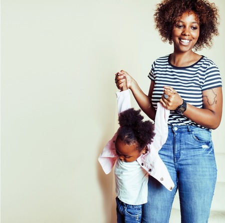 adorable sweet young afro-american mother with cute little girl, lifestyle people conceptの写真素材