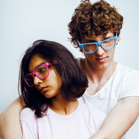 best friends teenage girl and boy together having fun, posing emotional on white background, couple happy smiling, lifestyle people concept, blond and brunette multi nations close upの写真素材